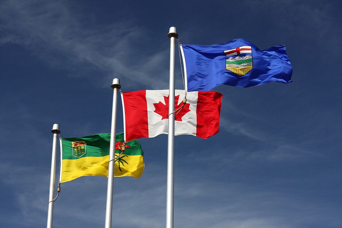 From left to right, the flags of Saskatchewan, Canada, and Alberta flying together in Lloydminster, Saskatchewan/Alberta
