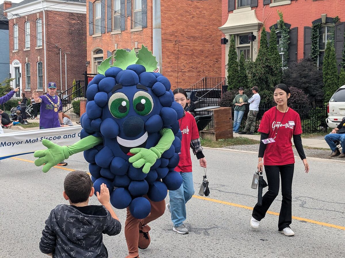 The grape mascot at the 2024 Grape and Wine Festival Parade