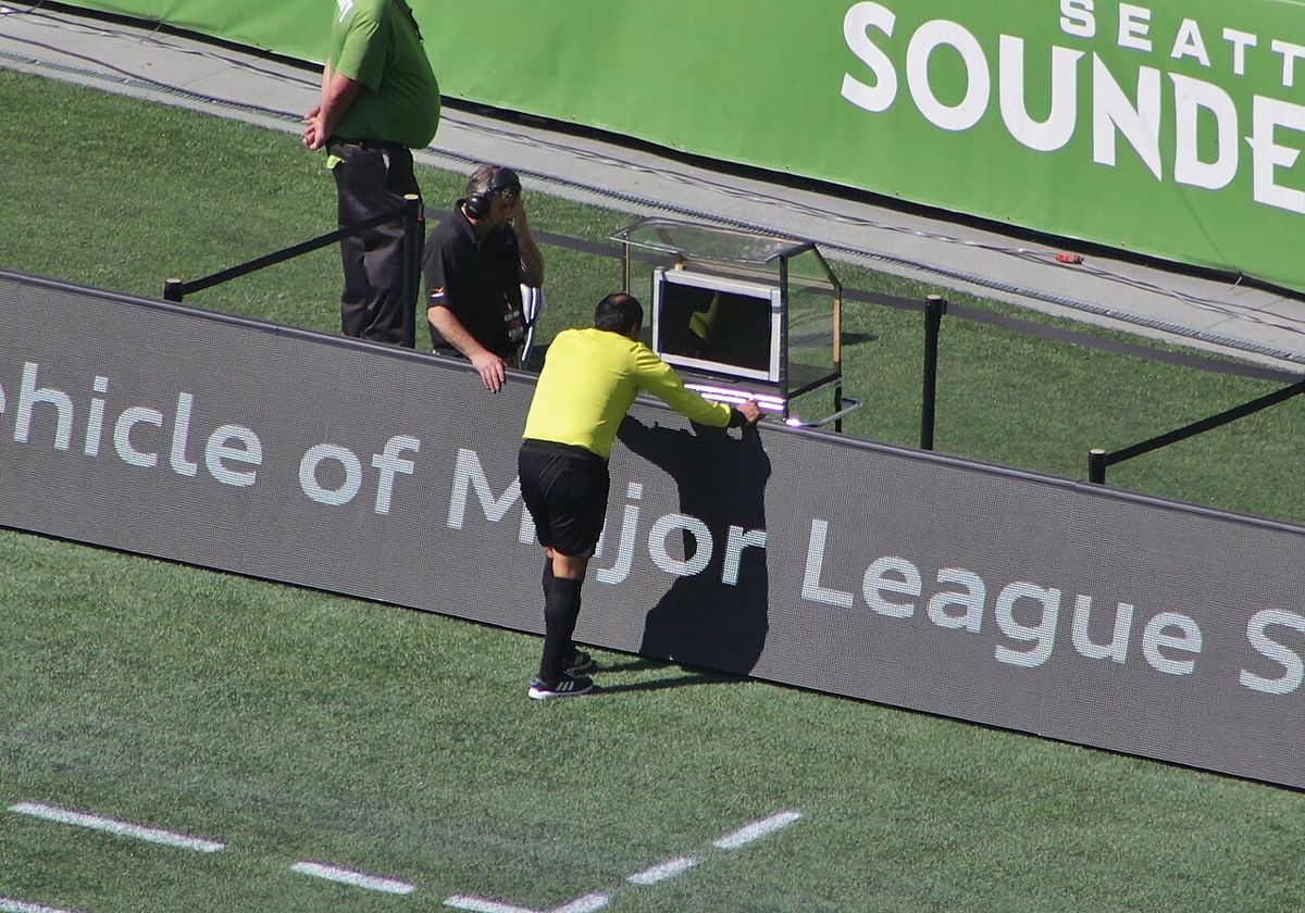 Referee Baldomero Toledo consults the video assistant referee during a Major League Soccer match between Seattle Sounders FC and Sporting Ka