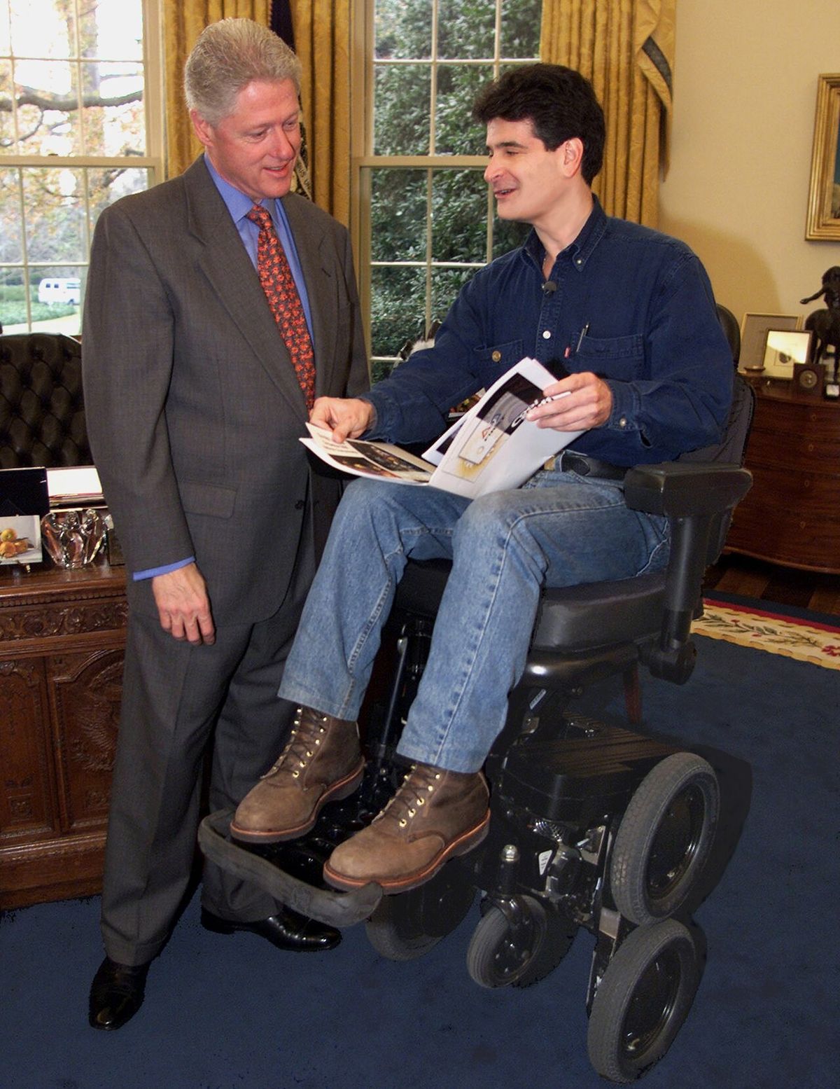 This picture shows Bill Clinton and Dean Kamen in the office of the president. Kamen is on his iBOT.