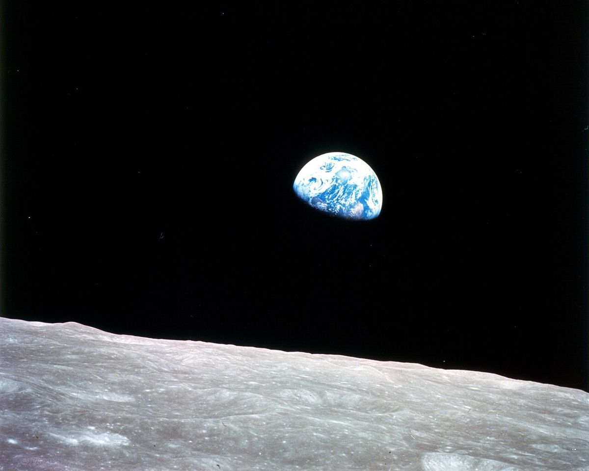This view of the rising Earth greeted the Apollo 8 astronauts as they came from behind the Moon after the fourth nearside orbit. Earth is ab