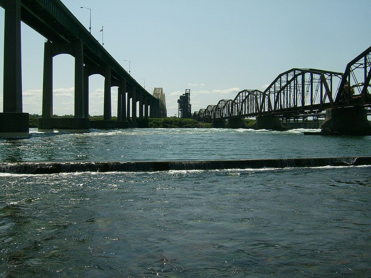 Sault Ste. Marie International Bridge (left) and International Railroad Bridge (right) spanning the St. Mary's Rapids.
