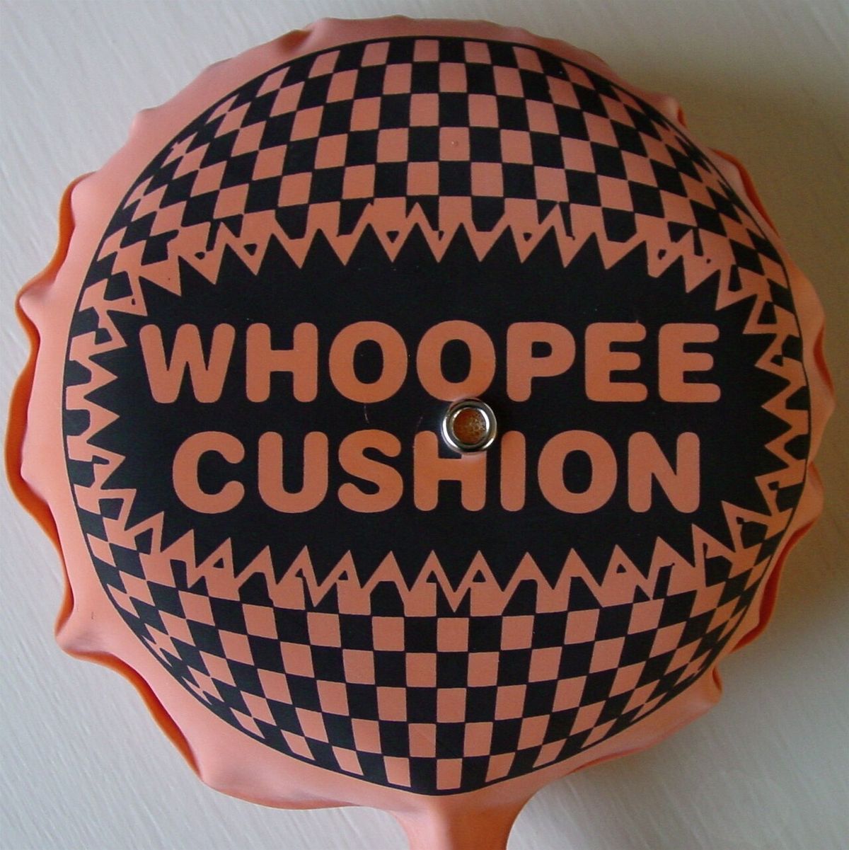 A self-reinflating whoopee cushion