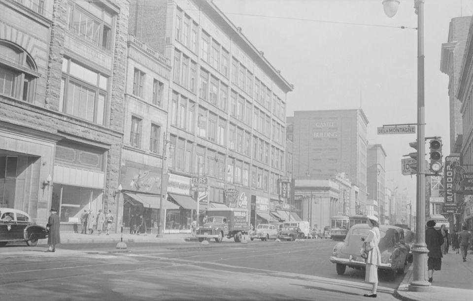We see the West St. Catherine Street near the rue de la Montagne in Montreal. We notice Marshall's and Kay's stores and "Castle Building".