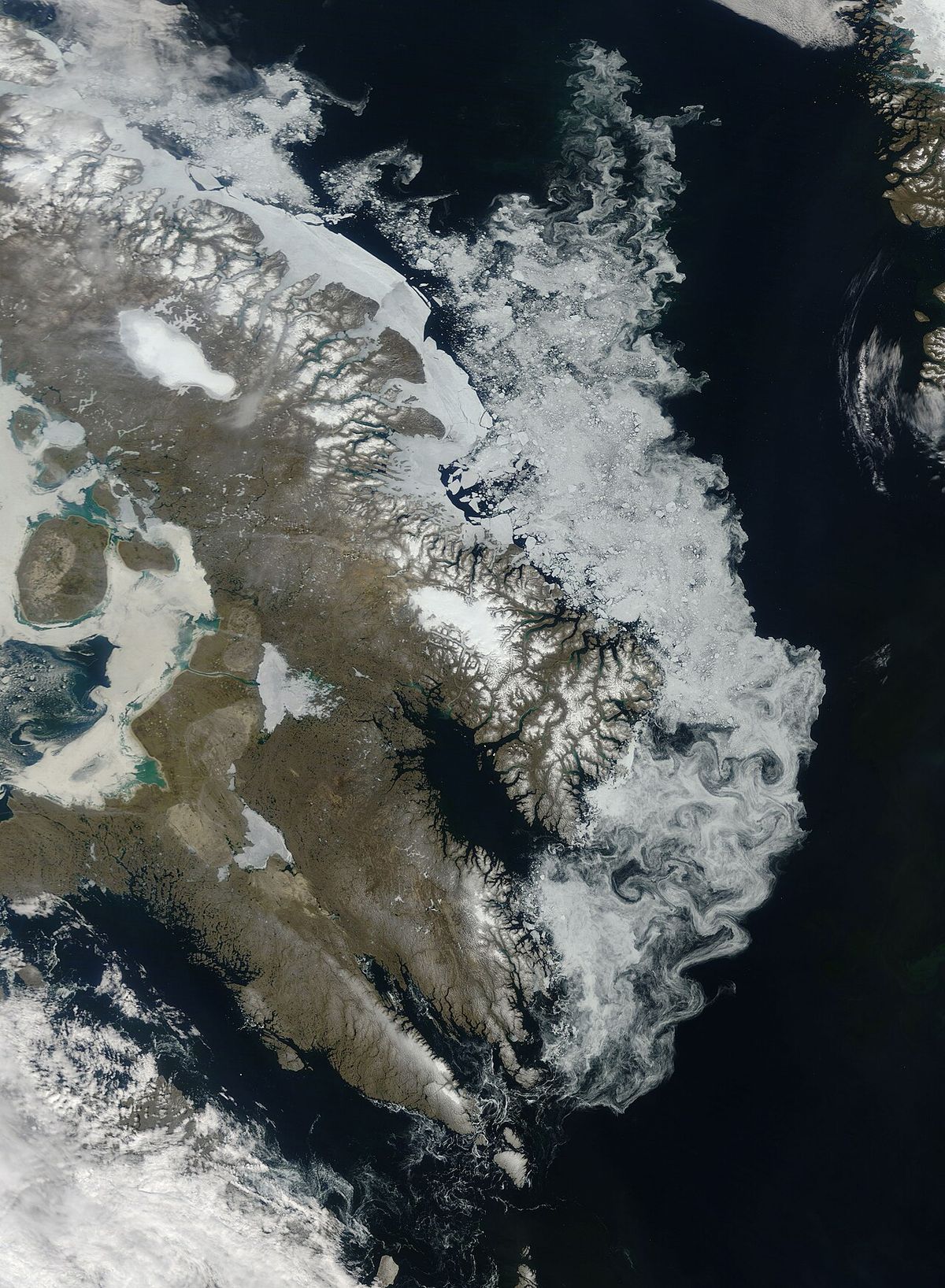 This natural-colour (photo-like) image shows winter ice hugging the coastline of Canada’s Baffin Island. Clouds often hover over the Arctic