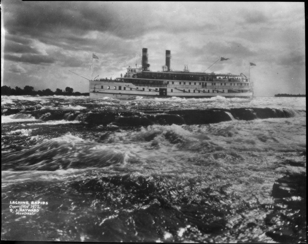 A boat passing above the Lachine Rapids near Montreal, Quebec. Caption: Lachine Rapids / Copyrighted 1922 / S.J. Hayward / Montreal